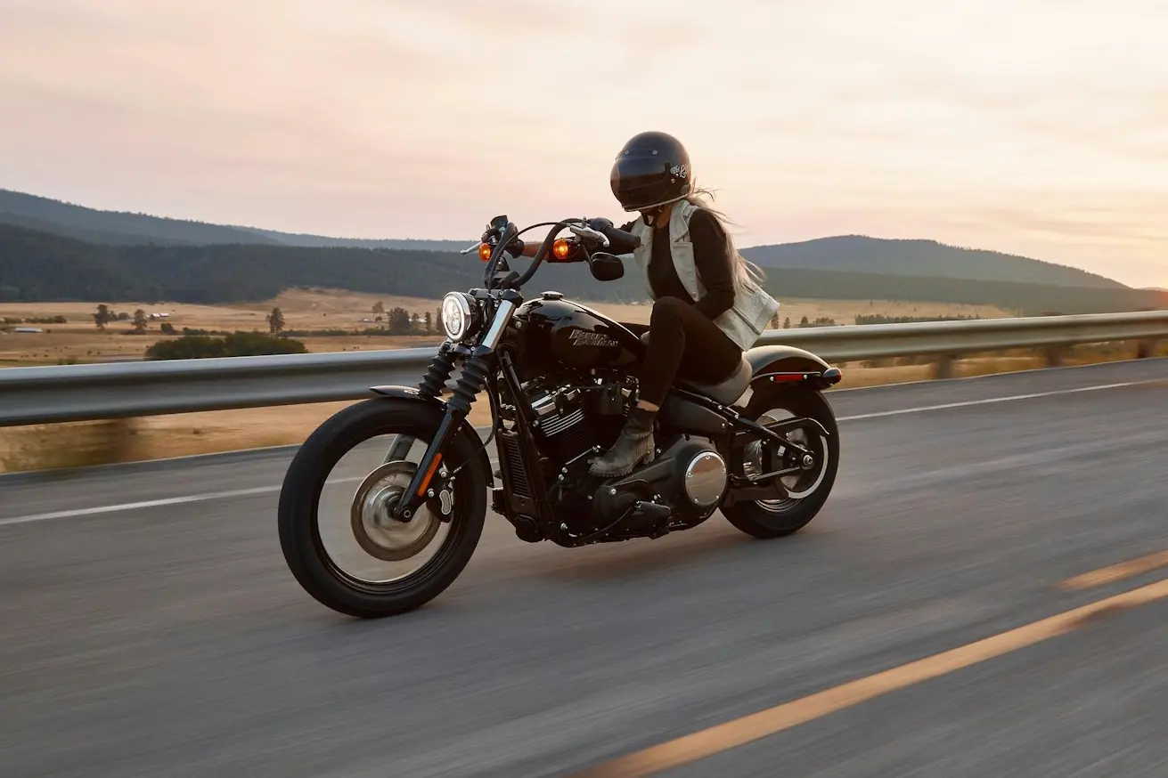 man on black cruiser motorcycle in highway